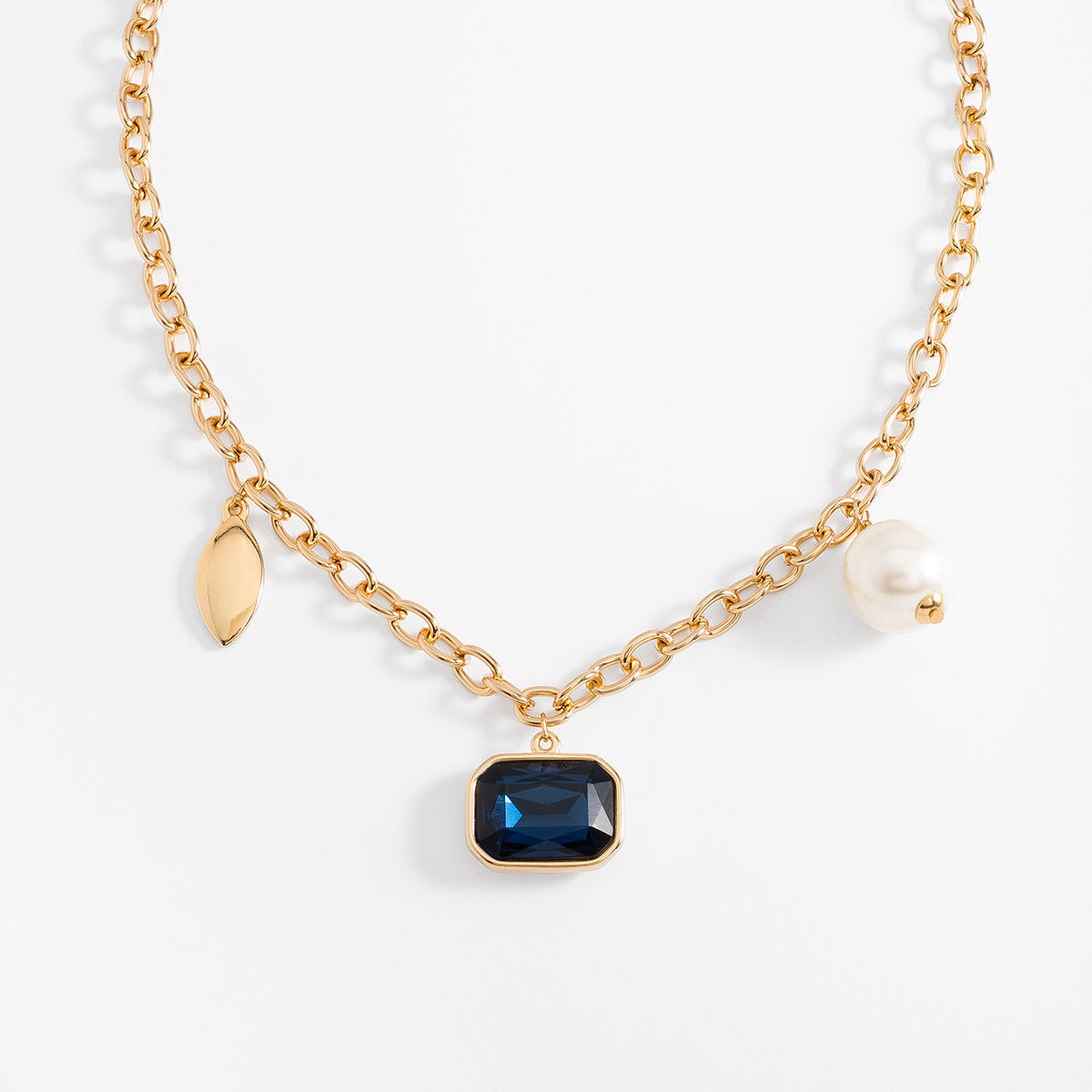 Collar en baño de oro con dije azul y perla sintética